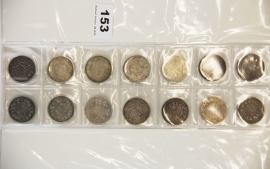A group of 14 Indian one rupee silver coins, dating from 1835 - 1920.