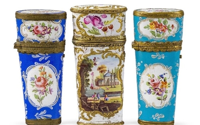 A group of three George III Staffordshire gilt-brass mounted enamel etui, late 18th century, comprising: an example with white ground decorated with alternating gilt c-scrolls, flowers and vignettes front and back of river scenes, the fitted...