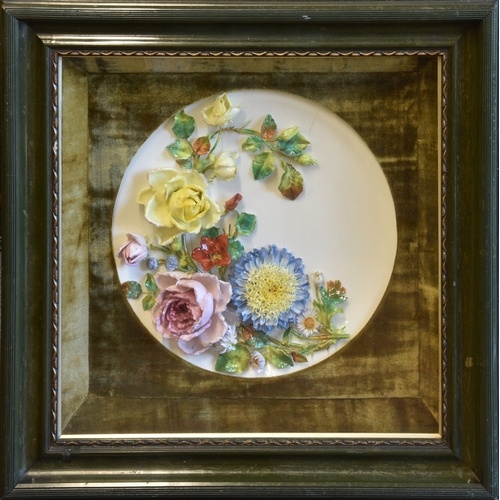 A late Victorian porcelain wall plaque of dished circular fo...