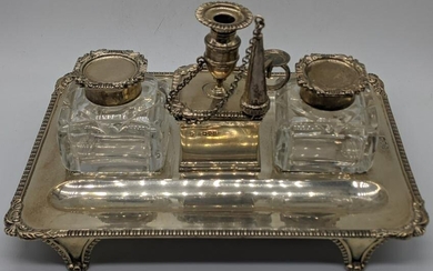 A late Victorian silver desk inkwell, central raised