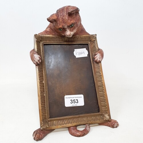 A painted bronze photograph frame, mounted with a ginger cat...
