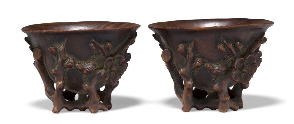 A pair of Chinese carved wood 'Three Friends of Winter' libation cups, late 19th century, carved to the exterior with plum blossom, bamboo and pine, each with a bird perched atop a branch, 4cm high (2) Note: The 'Three Friends of Winter' symbolise...