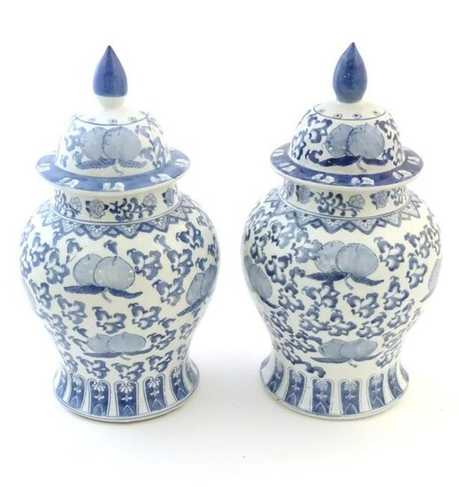A pair of Chinese lidded vases of baluster form