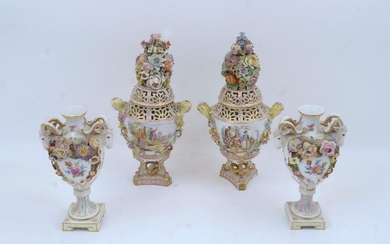 A pair of Dresden pot pourri urns and covers, c.1900, mark of Carl Thieme X and T, the pierced flower-encrusted covers above bodies with twin maiden-head handles, decorated with courting couples and blossoming flowers, tri-form base with wrythen...