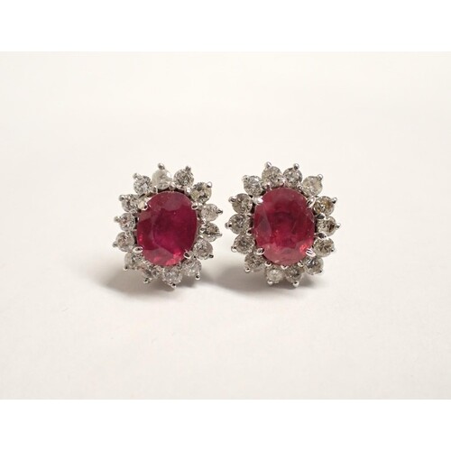 A pair of Ruby and diamond Cluster Earrings each claw-set ov...