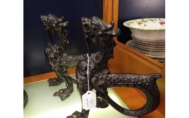 A pair of Victorian cast iron griffon form fire dogs