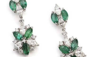A pair of emerald and diamond ear studs each set with numerous...