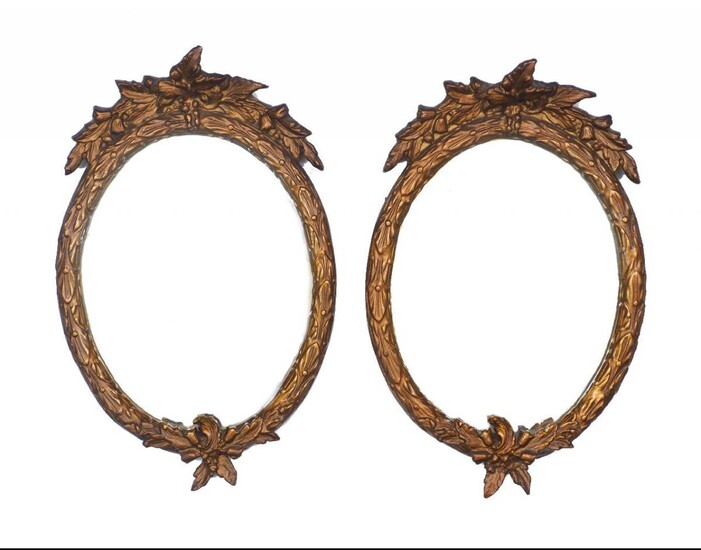 A pair of gilt-composition mirrors, late 20th century, with foliate frames, 35cm high; together with a gilt composition circular mirror and a gilt plaster putto wall bracket (4)