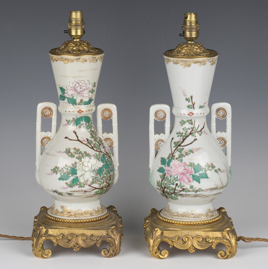 A pair of late 19th century Japanese export porcelain and ormolu mounted table lamps, the twin-handl