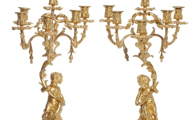 A pair of late 19th century gilt bronze candelabra, white marble bases....