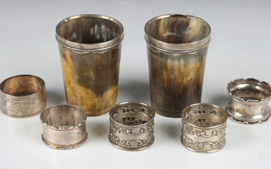 A pair of silver mounted horn beakers, height 9cm, a pair of Gorham sterling napkin rings and three