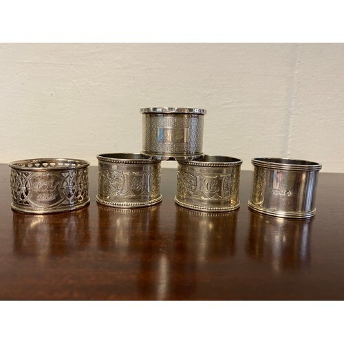 A pair of silver napkin rings, various dates and makers, to...