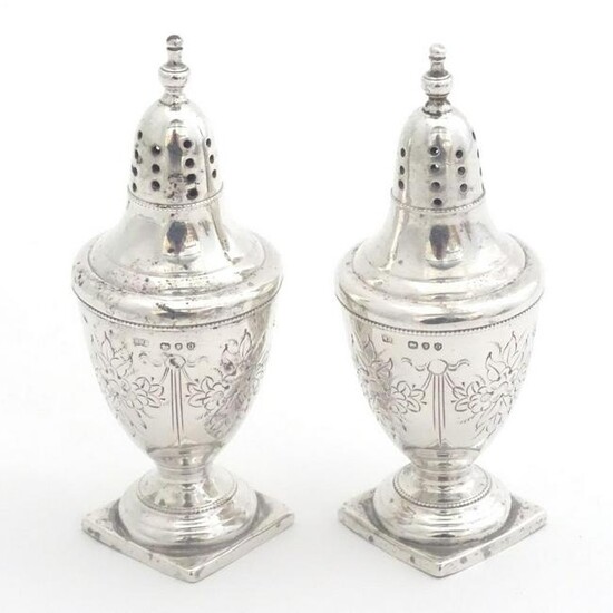 A pair of silver peppetettes of urn shape of square