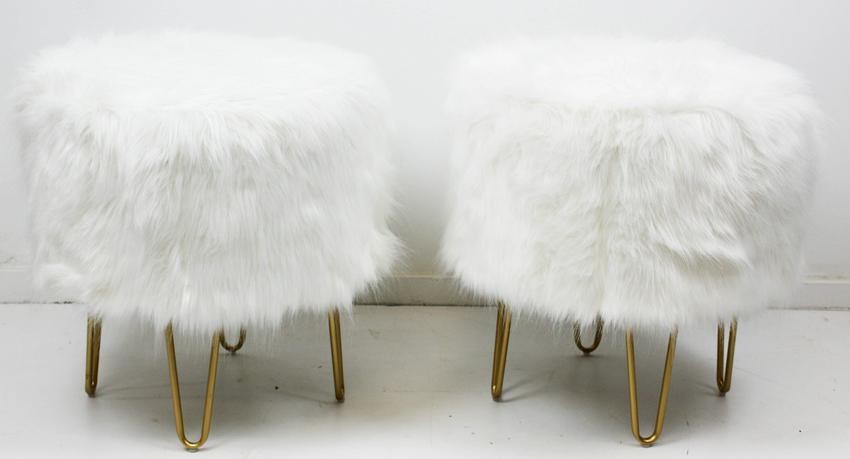 A pair of white fur round foot stools