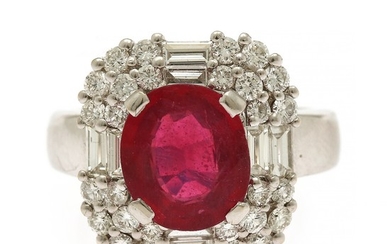 A ruby- and diamond ring set with an oval-cut ruby weighing app. 2.80 ct. encircled by numerous baguette and brilliant-cut diamonds, mounted in 18k white gold.