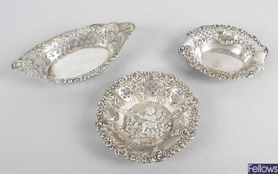 A selection of small pierced or embossed silver dishes. (8).