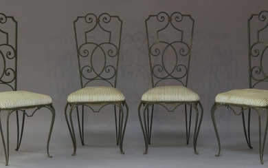 A set of four wrought iron and green painted chairs...