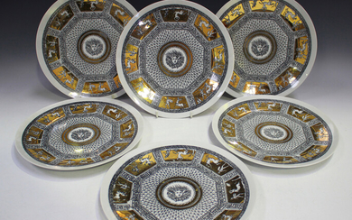 A set of six Fornasetti plates, each printed in black with classical panels heightened in gilt withi