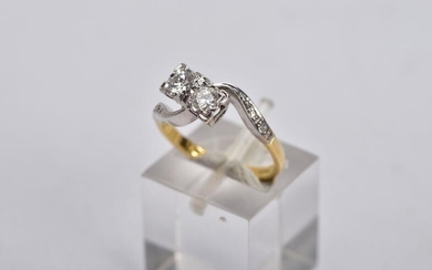 AN 18CT GOLD DIAMOND CROSS OVER RING, designed with...