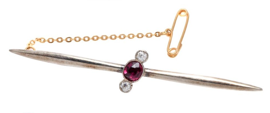 AN ANTIQUE RUBY AND DIAMOND BAR BROOCH; 70mm long pointed bar diagonally set with an approx. 0.70ct oval ruby and 2 Old European cut...