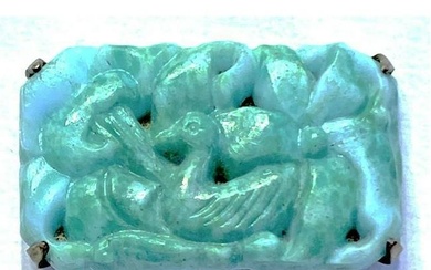 AN UNUSUAL DIVISION ONE CARVED JADE PICTORIAL BUTTON
