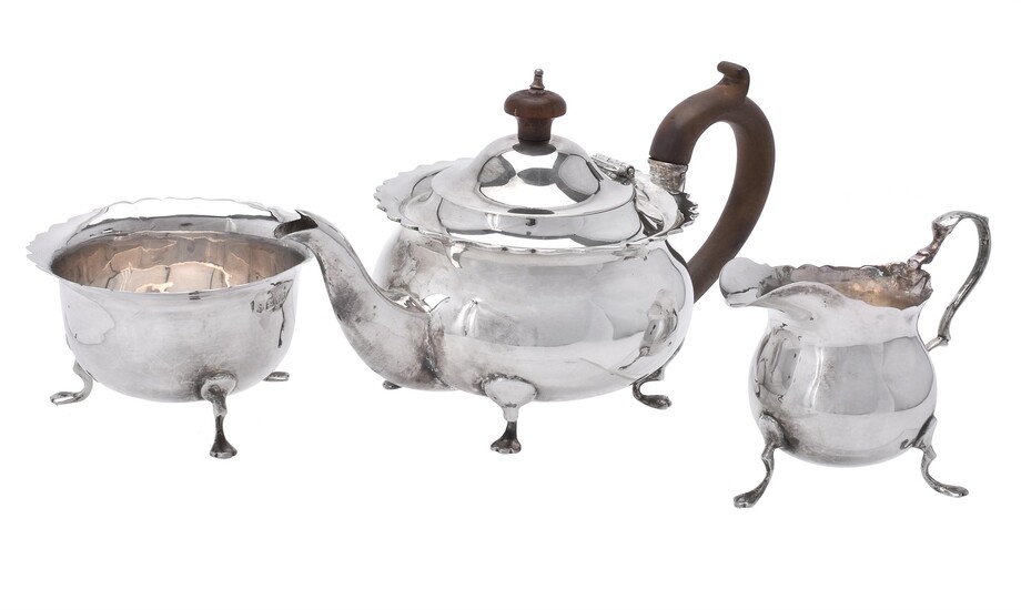 An Edwardian silver circular three piece tea set by George Nathan & Ridley Hayes