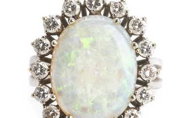 SOLD. An opal and diamond ring set with a cabochon opal weighing app. 5.19 ct. encircled by brilliant-cut diamonds weighing app. 1.05 ct., mounted in 18k white gold. – Bruun Rasmussen Auctioneers of Fine Art