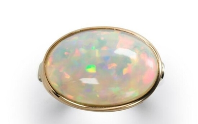 An opal and fourteen karat bi-color gold ring