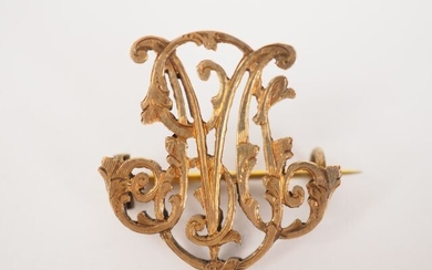 Brooch in yellow gold with monogram decoration.
