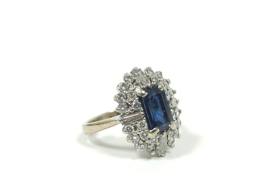 Diamond and sapphire oval cluster ring with four tapering ba...
