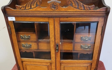 Edwardian oak free standing table cabinet enclosed by two...
