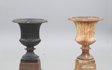 GARDEN URNS, two pieces, cast iron, on plinth.