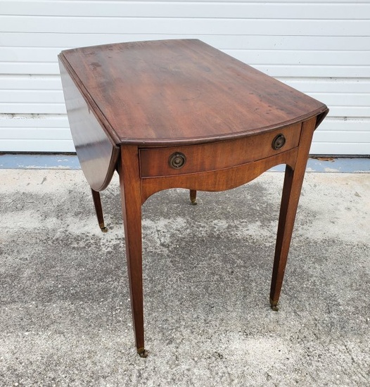 GEORGE III STYLE MAHOGANY PEMBROKE TABLE, Circa 1790. With molded bowed ends and molded elliptical