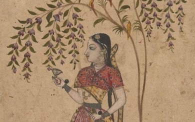 Girl holding a Wine Cup and Bottle standing under a Tree, North Deccan, possibly Maratha, India, early 18th century, opaque pigments heightened with silver and gold on paper, 18.5 x 12.5cm. A young girl standing under a flowering tree is one of the...