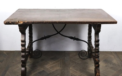Moulded and carved wood table, wrought iron spacer.