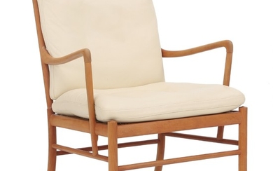 Ole Wanscher: “Colonial”. Armchair with cherry frame, seat with woven cane. Cushions in seat and back upholstered with cream coloured leather.