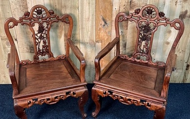 Pair of Chinese hardwood arm chairs. The top rail and centra...