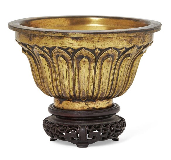 Property of a Gentleman (lots 36-85) A Sino-Tibetan gilt-bronze 'lotus' bowl, Qianlong mark and probably of the period, of ogee form with flat everted rim, finely cast to the sides with vertical lotus petals, incised with four-character Qianlong...