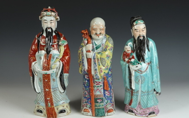 THREE CHINESE POLYCHROME AND GILT DECORATED PORCELAIN FIGURES OF STANDING...