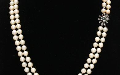 Two-row pearls choker with diamonds and emeralds clasp, circa 1960 - 1970.