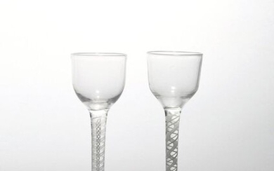 Two wine glasses c.1760-70, with small rounded funnel bowls raised...