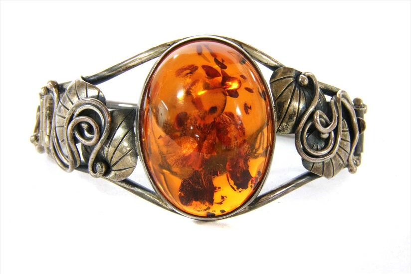 A sterling silver hinged amber bangle