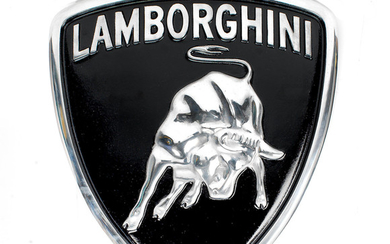 A painted cast aluminium sign depicting the Lamborghini badge