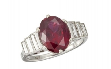 A platinum, ruby and diamond ring, the...