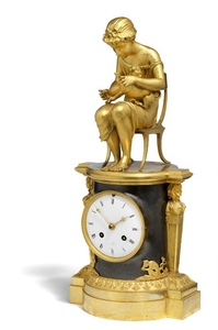 884/154: A French Empire gilt and patinated bronze figural mantel clock. Early 19th century. H. 42 cm. W. 19 cm.