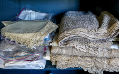 One bin of assorted textiles, including tablecloths, lace placemats, linen napkins, etc