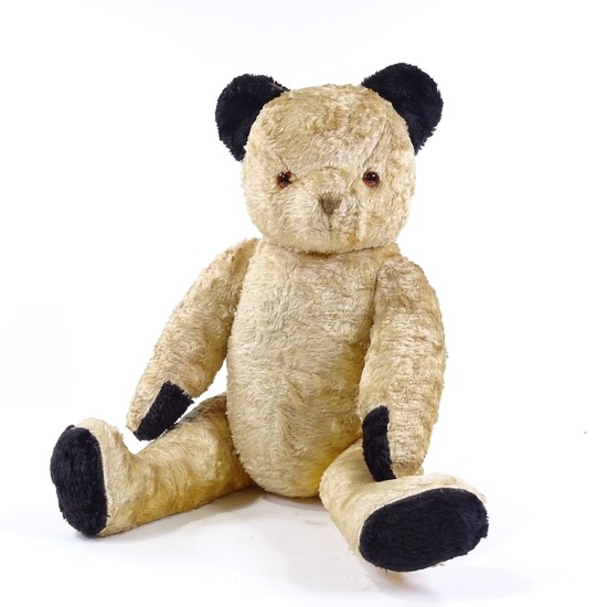 A 1950s gold plush straw-filled Sooty Teddy Bear, black pad ...