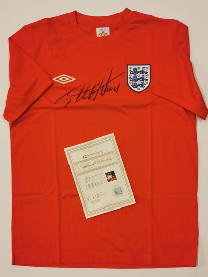 A 1966 England replica jersey t-shirt signed by Sir Geoff Hurst (British, b. 1941) with certificate.