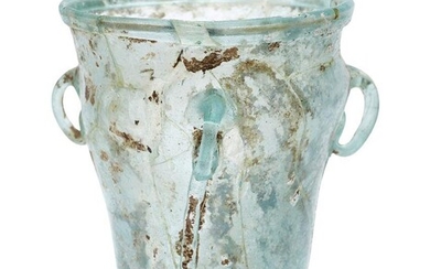 A Byzantine pale bluish-green glass hanging lamp, 6th-7th century, with three loop suspension handles to shoulder, 11cm. high
