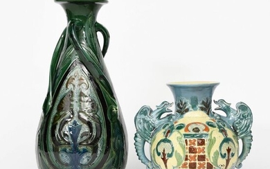 A C H Brannam Barnstaple Dragon vase by James Dewdney, dated 1895, ovoid with flaring neck, applied with two modelled dragon handles, the body slip decorated with stylised foliage panels, in green, blue and brown on a cream ground, and a tall C H...